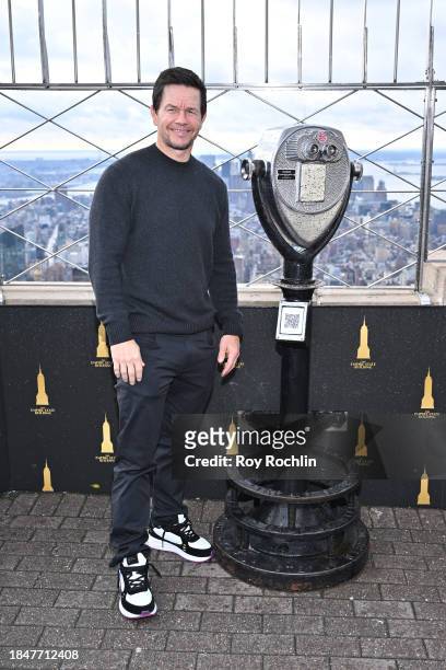 Mark Wahlberg poses as the cast of Apple TV's “The Family Plan” visits the Empire State Building at The Empire State Building on December 11, 2023 in...