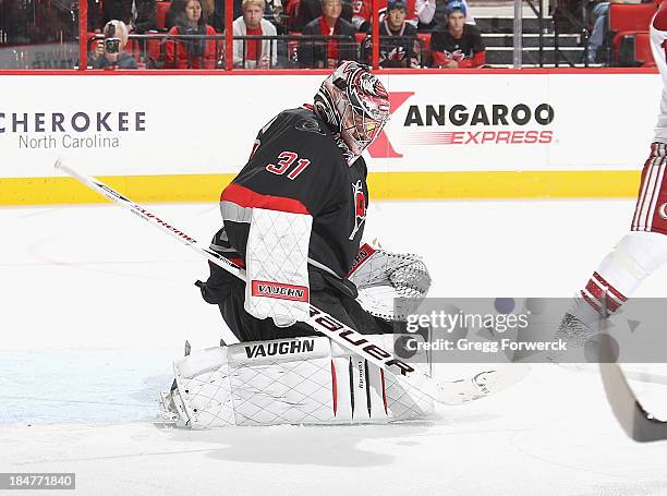 Anton Khudobin of the Carolina Hurricanes goes down in the crease to make a save during their NHL game against the Phoenix Coyotes at PNC Arena on...