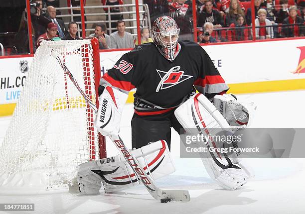 Cam Ward of the Carolina Hurricanes makes a save and plays the puck outside the crease during their NHL game against the Phoenix Coyotes at PNC Arena...