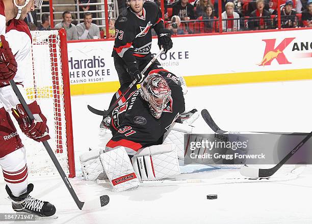 Anton Khudobin of the Carolina Hurricanes goes down in the crease to make a save against the Phoenix Coyotes during their NHL game at PNC Arena on...