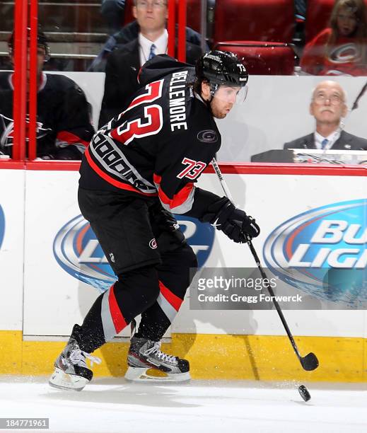 Brett Bellemore of the Carolina Hurricanes skates with the puck along the boards against the Phoenix Coyotes during their NHL game at PNC Arena on...