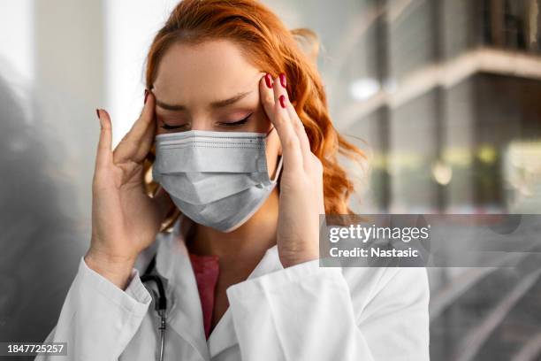 serious female doctor attending to duties outside - epidemics stock pictures, royalty-free photos & images