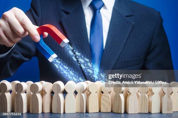 midsection of businessman holding toy blocks against blue background - penalty fee stock pictures, royalty-free photos & images