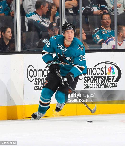 Logan Couture of the San Jose Sharks handles the puck against the New York Rangers during an NHL game on October 8, 2013 at SAP Center in San Jose,...