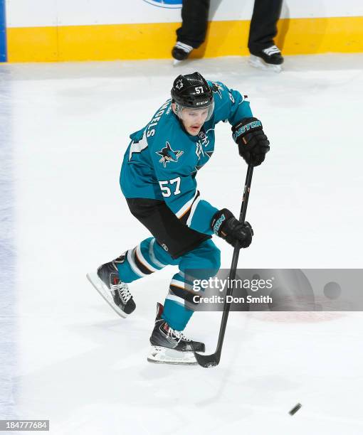 Tommy Wingels of the San Jose Sharks passes the puck against the New York Rangers during an NHL game on October 8, 2013 at SAP Center in San Jose,...