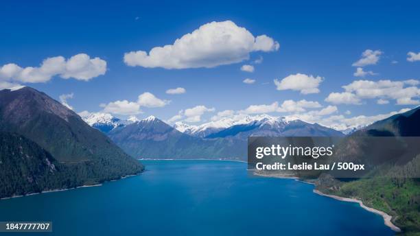 scenic view of lake and mountains against blue sky - leslie stock pictures, royalty-free photos & images