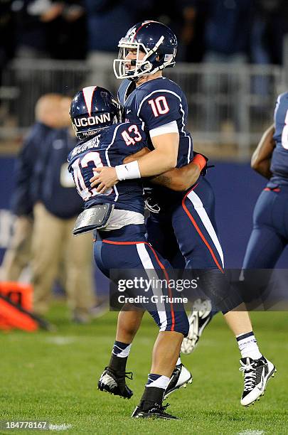 Chandler Whitmer of the Connecticut Huskies celebrates with Lyle McCombs after a touchdown against the Maryland Terrapins at Rentschler Field on...