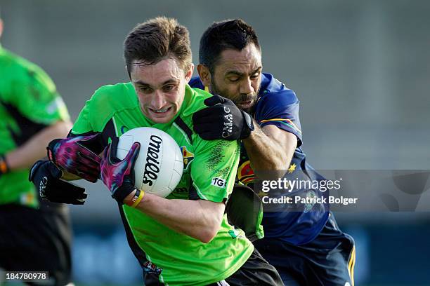 Nathan Lovett-Murray of the AFL Australian International Rules team tackles Glen Whelan of the Combined Dublin Colleges team during a practice match...