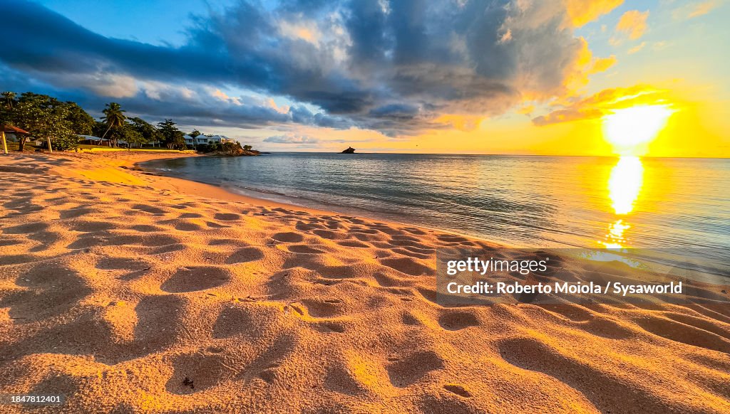 Dramatic sunset over a golden sand beach