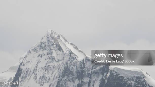 low angle view of snowcapped mountain against sky - leslie stock pictures, royalty-free photos & images