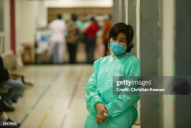 Staff member at the Prince of Wales hospital wears a face masks in an effort to protect herself from a deadly and contagious respiratory virus March...