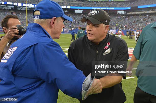 Head coach Chip Kelly of the Philadelphia Eagles and head coach Tom Coughlin of the New York Giants shake hands after the game at MetLife Stadium on...