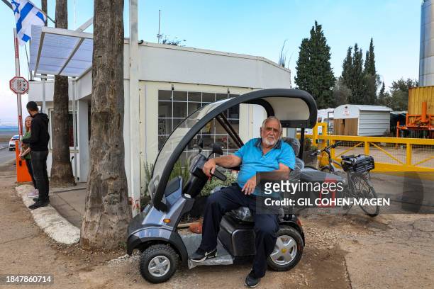 Ariye Oren, an Israeli from Kibbutz Nahal Oz, looks on in his vehicle at Kibbutz Mishmar Haemek in northern Israel on December 12, 2023. Kibbutz...