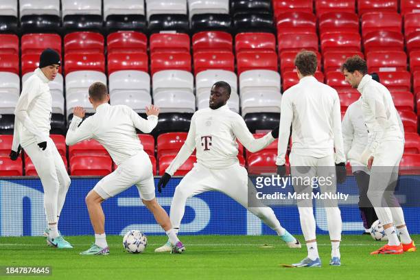 Dayot Upemecano of Bayern Munich warms up during a training session at Old Trafford on December 11, 2023 in Manchester, England.