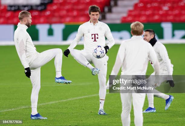 Thomas Mueller of Bayern Munich warms up with teammates during a training session at Old Trafford on December 11, 2023 in Manchester, England.