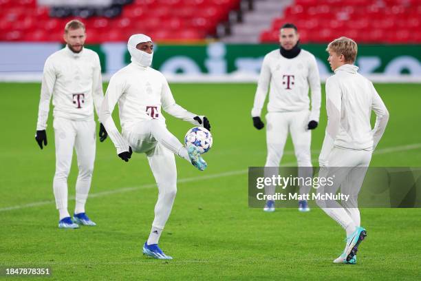 Mathys Tel of Bayern Munich warms up during a training session at Old Trafford on December 11, 2023 in Manchester, England.