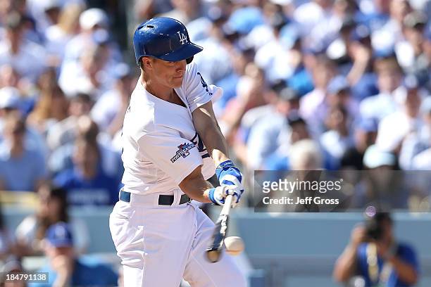 Zack Greinke of the Los Angeles Dodgers hits a RBI single in the second inning against the St. Louis Cardinals in Game Five of the National League...