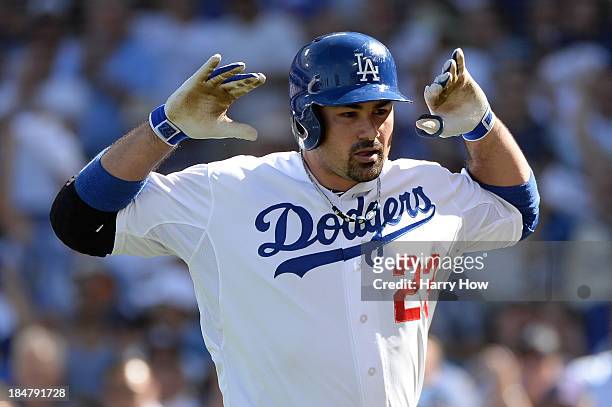 Adrian Gonzalez of the Los Angeles Dodgers reacts after he hits a solo home run in the third inning against the St. Louis Cardinals in Game Five of...