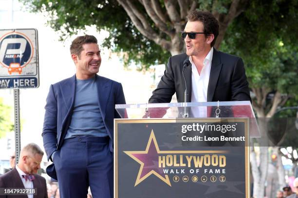 Zac Efron and Miles Teller speak onstage during the Hollywood Walk of Fame Star Ceremony Honoring Zac Efron on December 11, 2023 in Hollywood,...