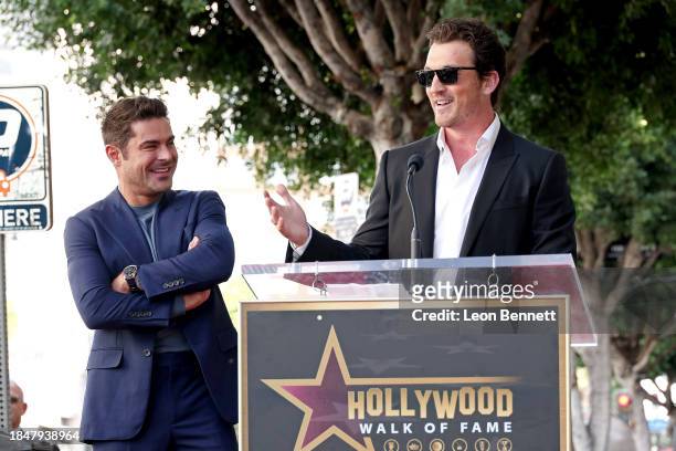 Zac Efron and Miles Teller speak onstage during the Hollywood Walk of Fame Star Ceremony Honoring Zac Efron on December 11, 2023 in Hollywood,...