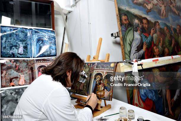 Restorer works on a 1450's nativity scene painting at Vatican Museums Restoration Laboratory during “Beyond the surface. The restorer's gaze": the...
