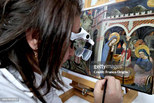 Restorer works on a 1450's nativity scene painting at Vatican Museums Restoration Laboratory during “Beyond the surface. The restorer's gaze": the...