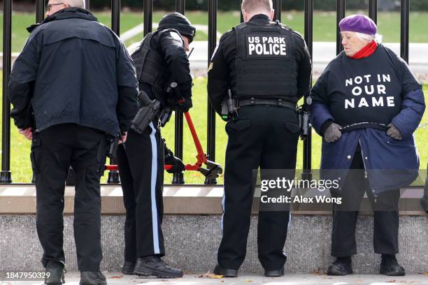 Activists chain themselves to the fence of the White House during a protest on the Israel/Hamas war on December 11, 2023 in Washington, DC. Jewish...