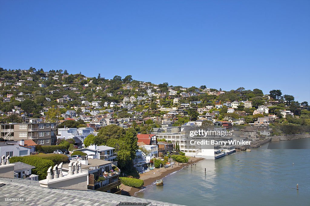 Vista of calm water & buildings climbing hillside