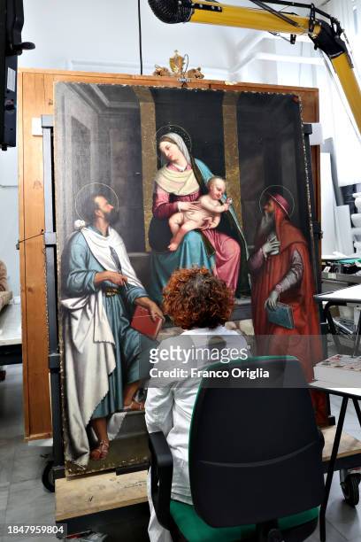 Restorer works on a painting at Vatican Museums Restoration Laboratory during “Beyond the surface. The restorer's gaze": the exhibition initiative...