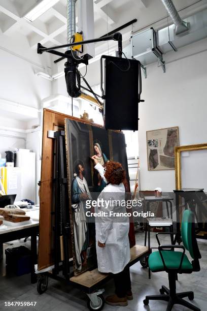 Restorer works on a painting at Vatican Museums Restoration Laboratory during “Beyond the surface. The restorer's gaze": the exhibition initiative...