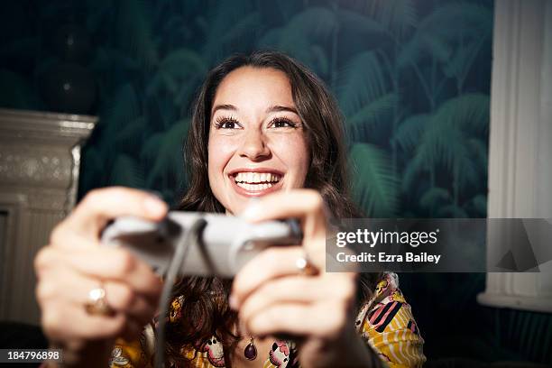 woman playing computer games. - games console stock-fotos und bilder