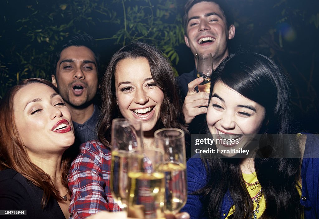 Friends celebrating with Champagne at a party.