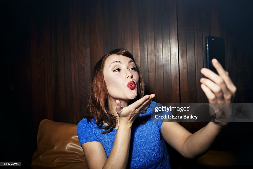 Woman posing and taking a photo of herself