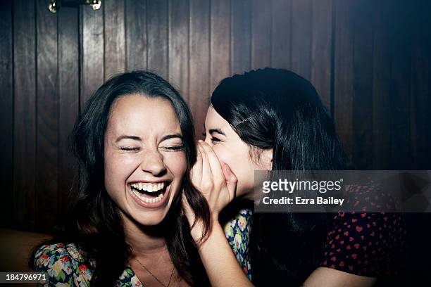 friends whispering to each other. - 20 29 years stock pictures, royalty-free photos & images