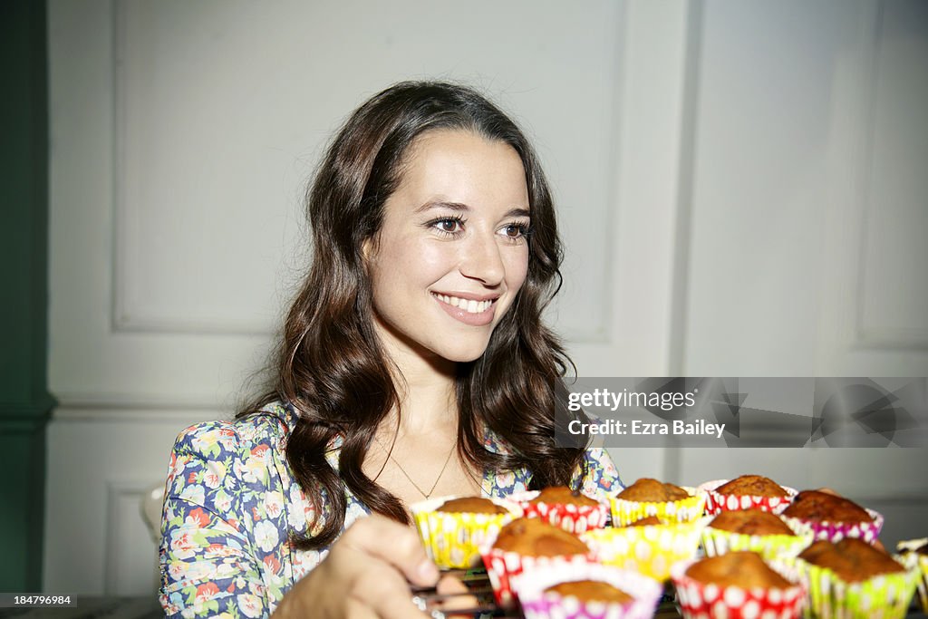 Woman with a tray of cupcakes