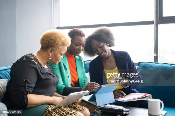 geschäftsfrauen brainstormen im sonnigen coworking-büro - brainstormen stock-fotos und bilder