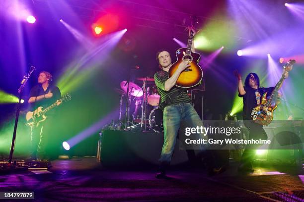 Brad Fernquist, John Rzeznik and Robby Takac of Goo Goo Dolls performs on stage at Manchester Academy on October 16, 2013 in Manchester, England.