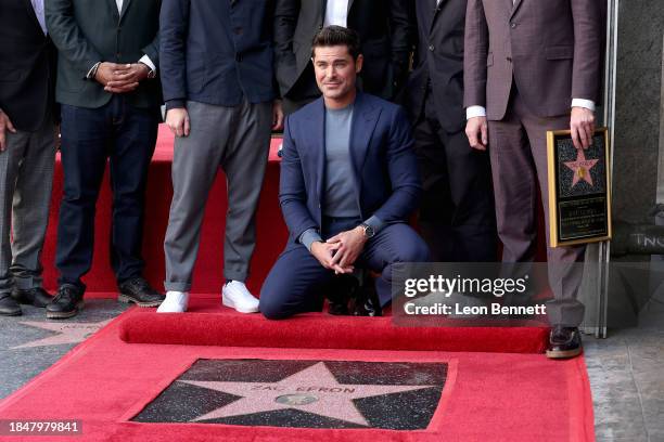 Zac Efron poses with his star during his Hollywood Walk of Fame Star Ceremony on December 11, 2023 in Hollywood, California.