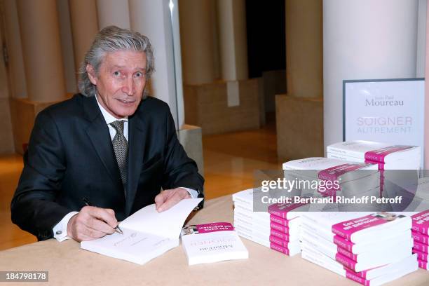 Jean-Paul Moureau signs his book 'Soigner Autrement' at Hotel Park Hyatt Paris Vendome on October 16, 2013 in Paris, France.