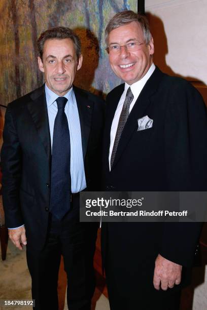 Nicolas Sarkozy and Area Vice president Michel Jauslin attend the Jean-Paul Moureau book signing for 'Soigner Autrement' at Hotel Park Hyatt Paris...