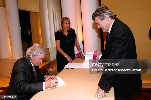 Politician Jean-Louis Borloo and Jean-Paul Moureau attend the Jean-Paul Moureau book signing for 'Soigner Autrement' at Hotel Park Hyatt Paris...