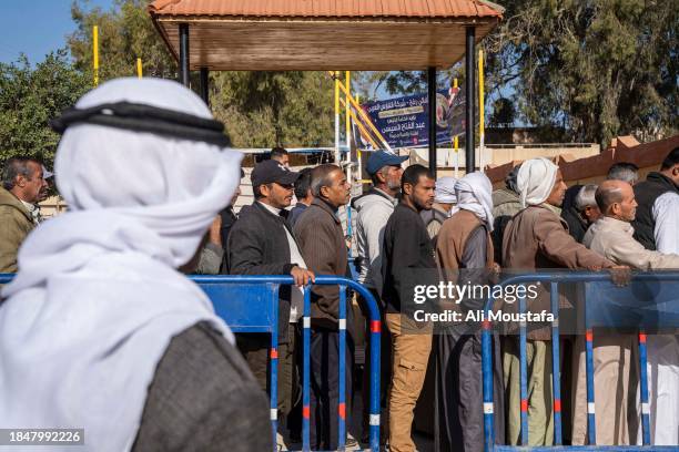 Citizens wait to cast their votes in the presidential elections on December 11, 2023 in Sheikh Zuweid, North Sinai near the Rafah crossing, Egypt....