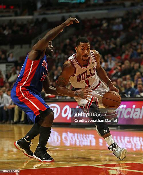 Derrick Rose of the Chicago Bulls drives against Will Bynum of the Detroit Pistons during a preseason game at the United Center on October 16, 2013...
