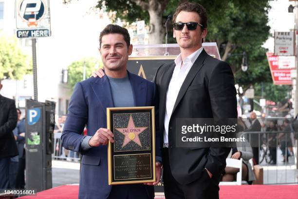 Zac Efron and Miles Teller attend the Hollywood Walk of Fame Star Ceremony Honoring Zac Efron on December 11, 2023 in Hollywood, California.