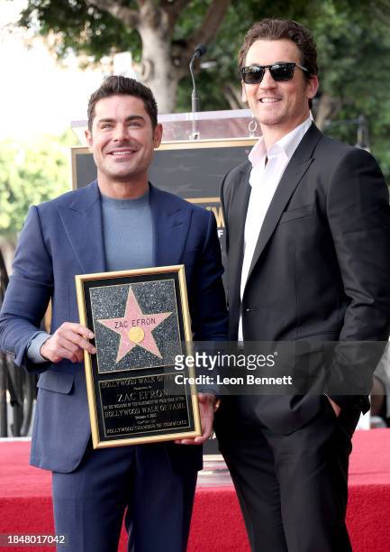 Zac Efron and Miles Teller attend the Hollywood Walk of Fame Star Ceremony Honoring Zac Efron on December 11, 2023 in Hollywood, California.