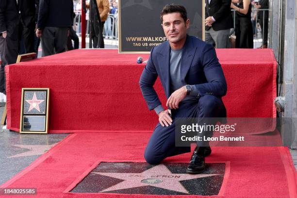 Zac Efron poses with his star during his Hollywood Walk of Fame Star Ceremony on December 11, 2023 in Hollywood, California.