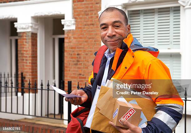 courier/postman delivering mail - postman stock-fotos und bilder