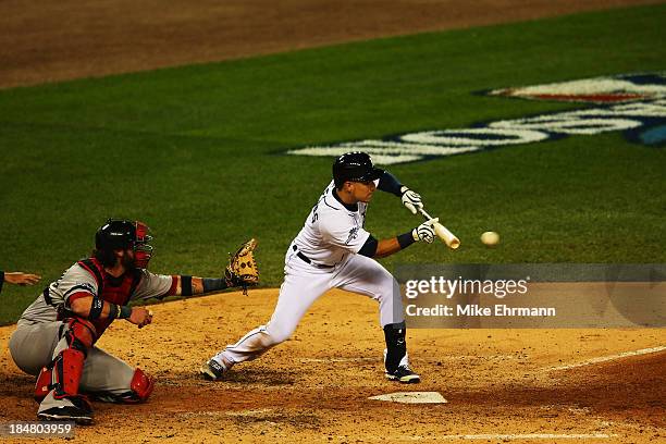 Jose Iglesias of the Detroit Tigers bunts in the fourth inning against the Boston Red Sox during Game Four of the American League Championship Series...