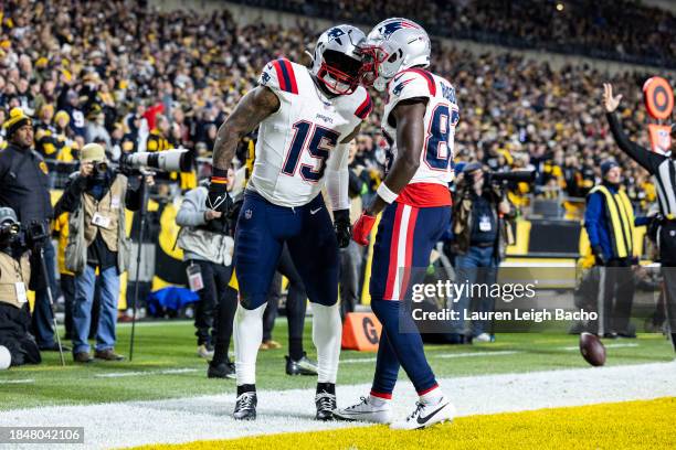 Ezekiel Elliott of the New England Patriots celebrates with Jalen Reagor after scoring a touchdown during the game against the Pittsburgh Steelers at...