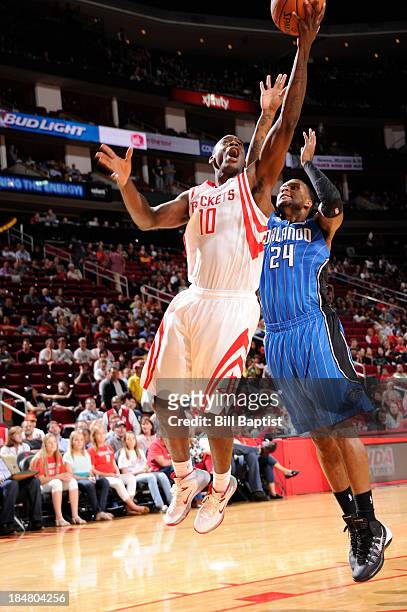 Ronnie Brewer of the Houston Rockets shoots the ball against Romero Osby of the Orlando Magic during a 2013 NBA pre-season game on October 16, 2013...